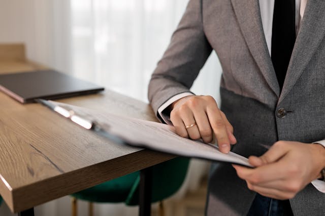 person reading documents on a clipboard